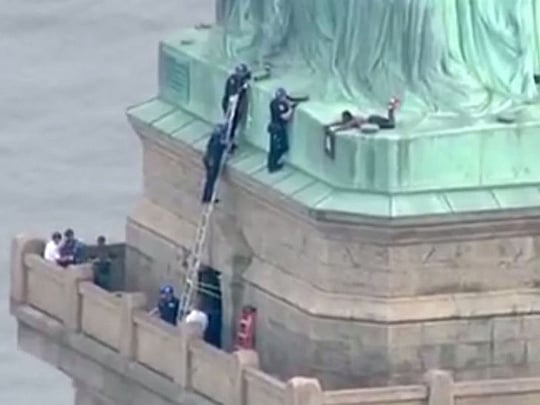 Protester climbs base of Statue of Liberty, forcing shutdown of landmark