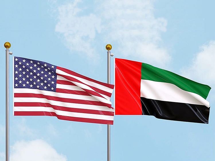 The American flag flies outside the U.S. Embassy in Abu Dhabi behind a secure perimeter fence.
