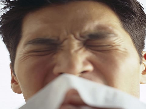 man sneezing
