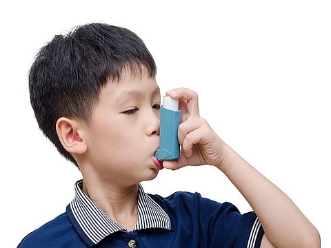 child with asthma inhaler