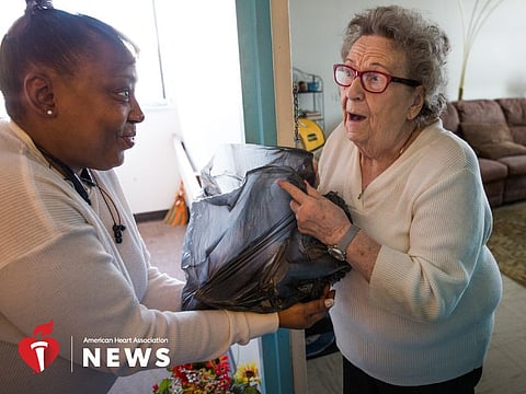 A volunteer distributes “rescued” food to a Pittsburgh resident.