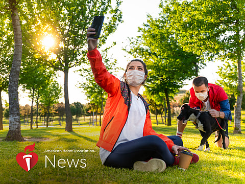 couple in the park wearing masks
