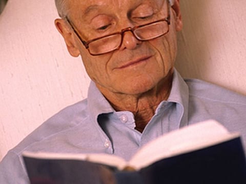 An Elderly Person Studying 