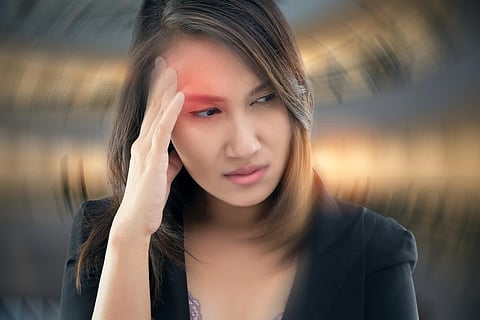 Working woman has Headache Against gray background, Benign Paroxysmal Positional Vertigo: BPPV