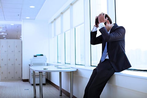 Depressed young businessman in office