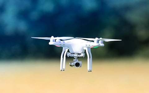 Flying drone, outdoor action on a defocused background. Royalty free image, no logos in the photo.