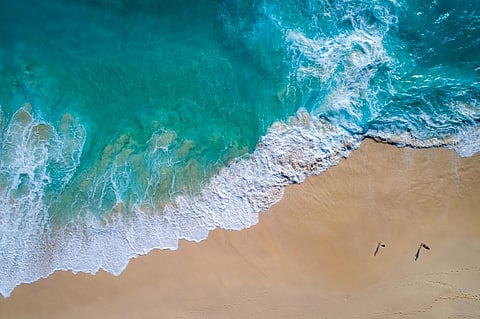 Aerial view to tropical sandy beach and blue ocean wave in Indonesia