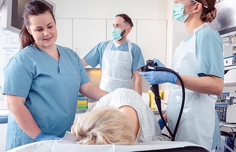 Patient and doctor in hospital during colonoscopy, closeup