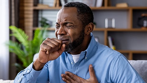 middle-aged man coughing, long COVID