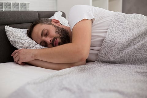 man sleeping in bed