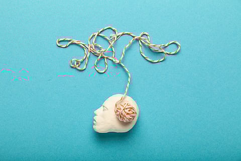 Photo of a head with yarn posed as the brain