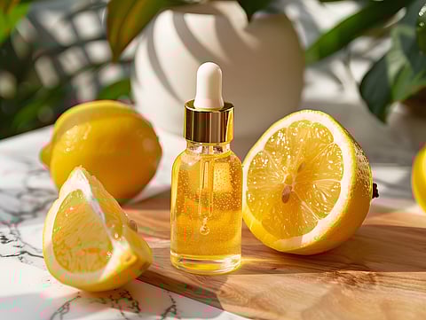 Photo of an essential oil and lemons on a wooden cutting board