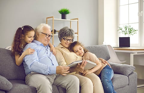 Grandparents reading to grandchildren