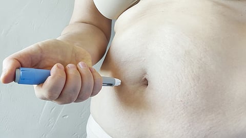 Woman giving herself an Ozempic injections