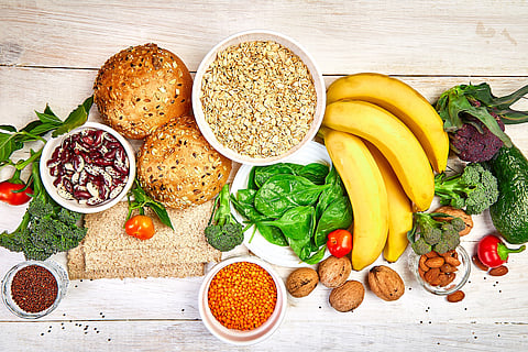 Selección de alimentos ricos en fibra sobre fondo de madera blanca, Producto alimenticio de dieta saludable. Vista superior, plano plano, espacio de copia.