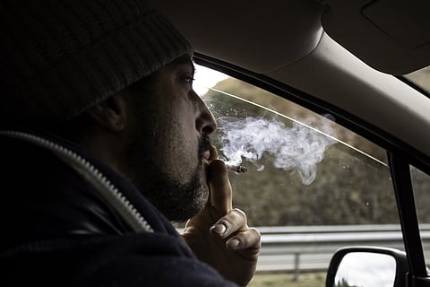 Man smoking pot in car