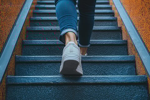 Woman walking up stairs, exercise snacks