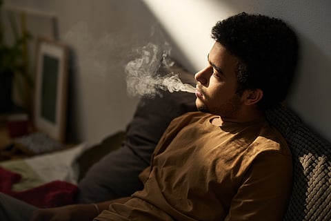 Teen smoking in bed