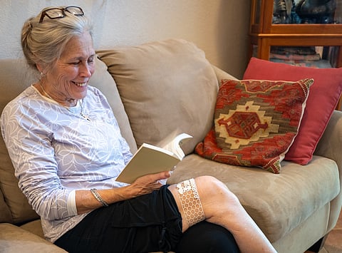 A female test subject wears an AI-powered mesh sleeve designed to test for frailty.