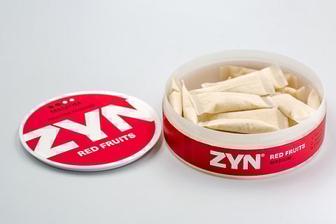 ZYN nicotine pouches red fruits medium strength container closeup.