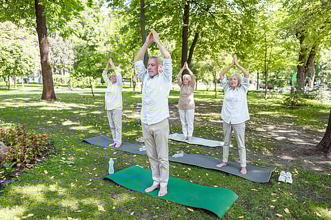 Group of elderly people practicing qigong in the park