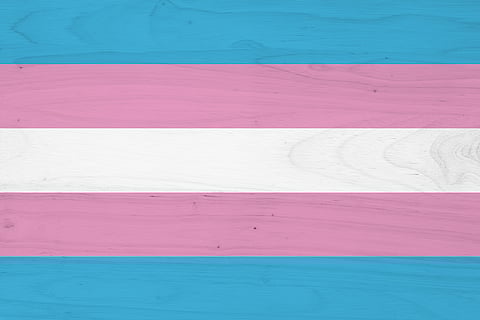 A transgender flag on with wood texture