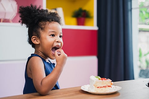 girl kid eating sweet cake