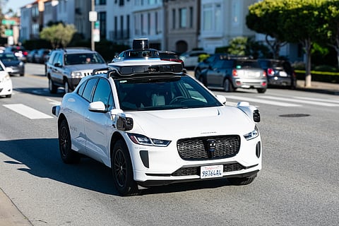 Waymo One Jaguar driverless autonomous car equipped with lidar sensors and cameras drives on a multi-lane city road. Front side view. Selective focus - San Francisco, California, USA - March 8, 2025