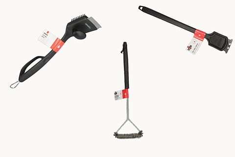 A photo of the recalled Nexgrill grill brushes and scrapers on a cream background