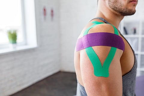athlete wearing KT tape for pain, movement