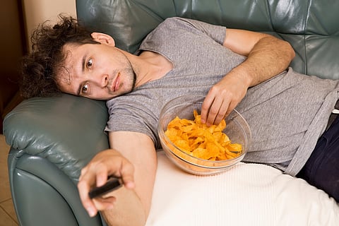 Man's relax after work, beer and chips. Lazy man