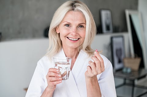 Woman taking a daily multivitamin 