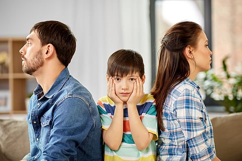 family problem, divorce and people concept - unhappy father, mother and sad little son at home