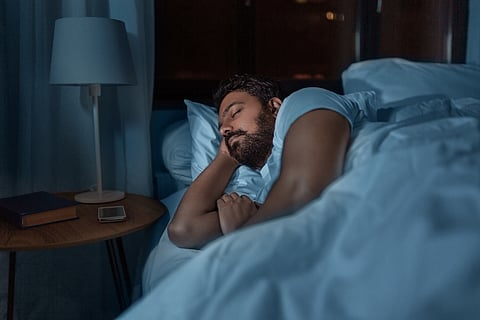 Middle-aged man sleeping in bed at night