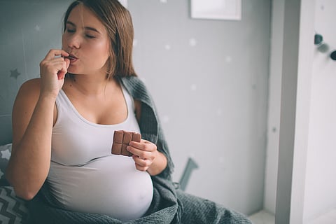 Pregnant Woman Eating Chocolate