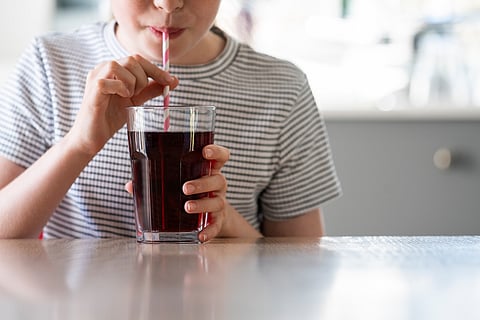 Child drinking soda, caffeine