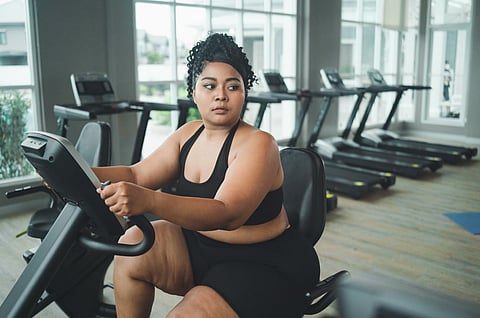 Una persona con sobrepeso haciendo ejercicio en un gimnasio