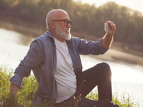Grandparent taking a selfie in the park