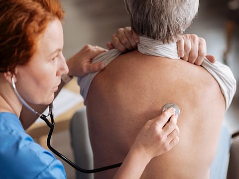 Take a deep breath. Skillful trained private doctor using professional stethoscope for hearing how elderly man breathing and diagnosing him
