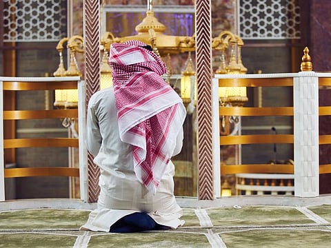 Religious muslim man praying inside the mosque