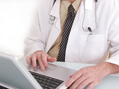 Doctor working on a notebook computer.