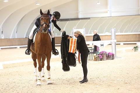 Voittoloimen päällepukemisen aika. Sabina Saloniemi ja Fürst Kimba Carrus ottivat voiton vaativa B-tasoisessa Pohjola Rising Star- finaalissa.  Tiina Polso ojentaa loimea. 