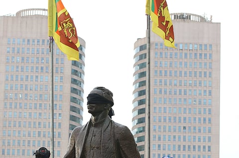 Former prime minister Sirimavo Ratwatte Dias Bandaranaike blindfolded in protest during the Aragalaya protests around Sri Lanka’s economic crisis in 2022. Bandaranaike founded the Sinhala Maha Sabha in 1937, and in 1956 passed the Sinhala Only Act which marginalised Tamils and eventually led to targeted anti-Tamil violence.