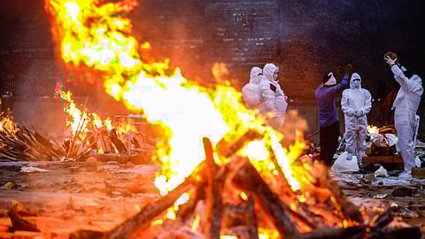 Relatives of Covid-19 victims performing last rites at a crematorium in New Delhi in May 2021. Data from India shows 3.7 million excess deaths during the pandemic years of 2020 and 2021, revealing an undercounting of Covid-19 deaths by an estimated seven times. 
