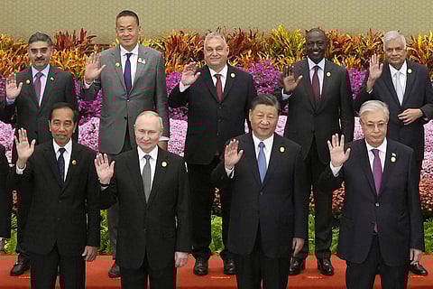 A group of world leaders, including Xi Jinping, pose for a photo during the Belt and Road Forum for International Cooperation in 2023 in front of a vibrant floral backdrop. In the front row, from left to right, are the presidents of Indonesia, Russia, China, and Kazakhstan. Leaders from other countries, including Pakistan, Thailand, Hungary, Kenya, and Sri Lanka, stand in the back row.