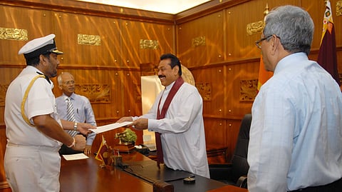 Admiral Wasantha Karannagoda (left) receives his appointment as National Security Advisor from Sri Lankan President Mahinda Rajapaksa (second from right) at a ceremony in Colombo in 2009. Two other officials stand nearby in the wood-panelled office.