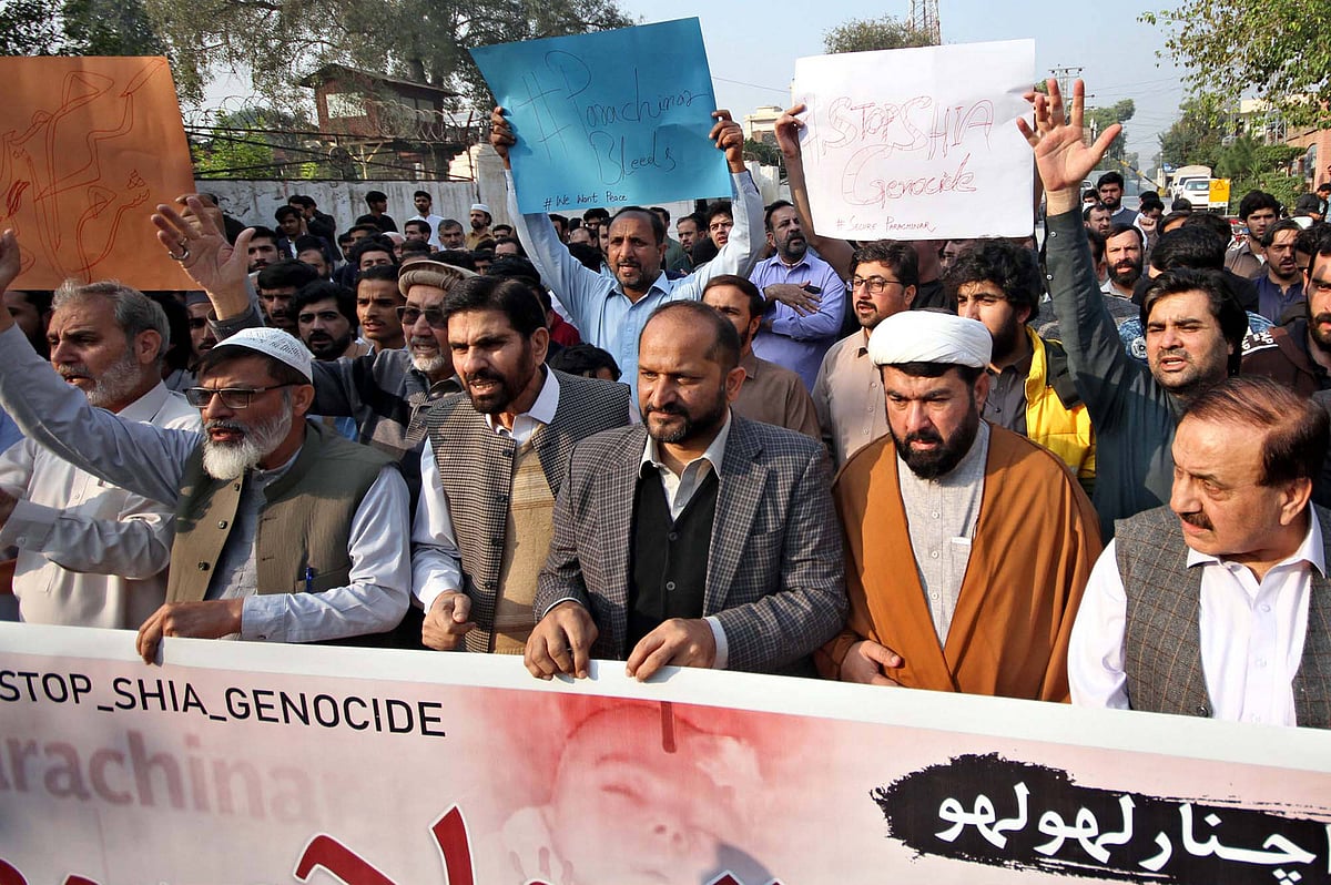 A group of residents of Parachinar at a protest against the recent terrorist attack in Parachinar, holding signs that read 's