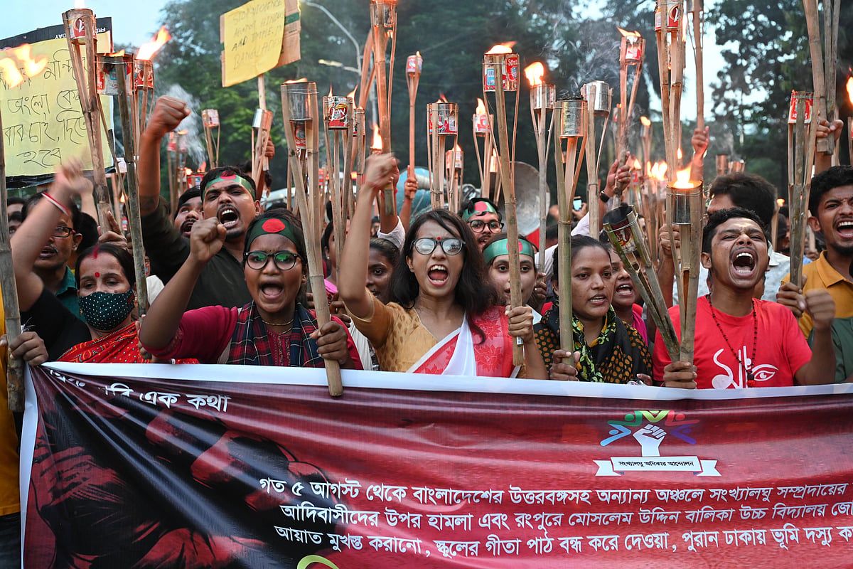 A group of Hindu protesters wearing red, carrying torches and placards, protesting anti-Hindu violence in Bangladesh