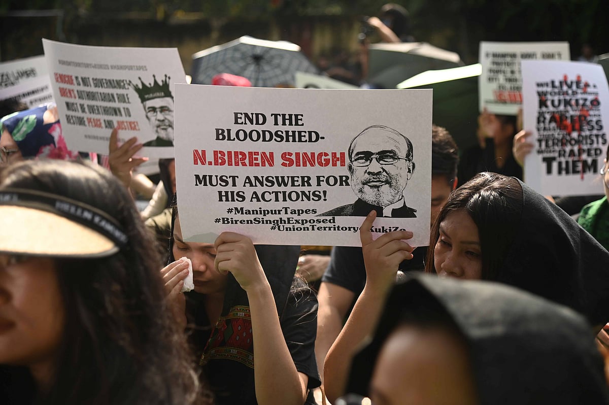 A group of protestors against Manipur’s chief minister with a sign that reads "End the bloodshed. N.Biren Singh must answer f