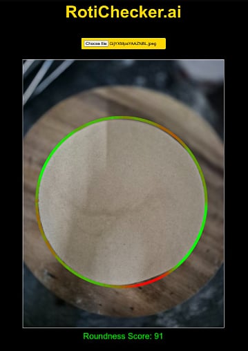 A photo showing a round roti on a wooden round chopping board. The roti is outlined in a mix of green and red. The outline is mostly green. Text at the bottom of the photo says 'Roundness score - 91'. Text at the top in yellow says Rotichecker.ai. There is a button allowing someone to upload a photo. This is supposed to be an AI tool checking the roundness of people's roti. 